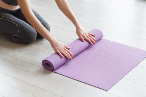 rolling out yoga mat 